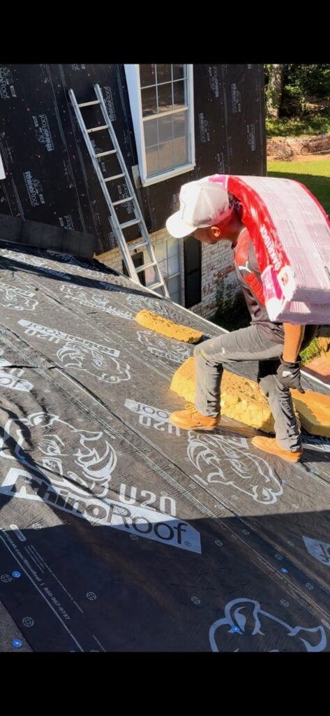 Person carrying materials on roof