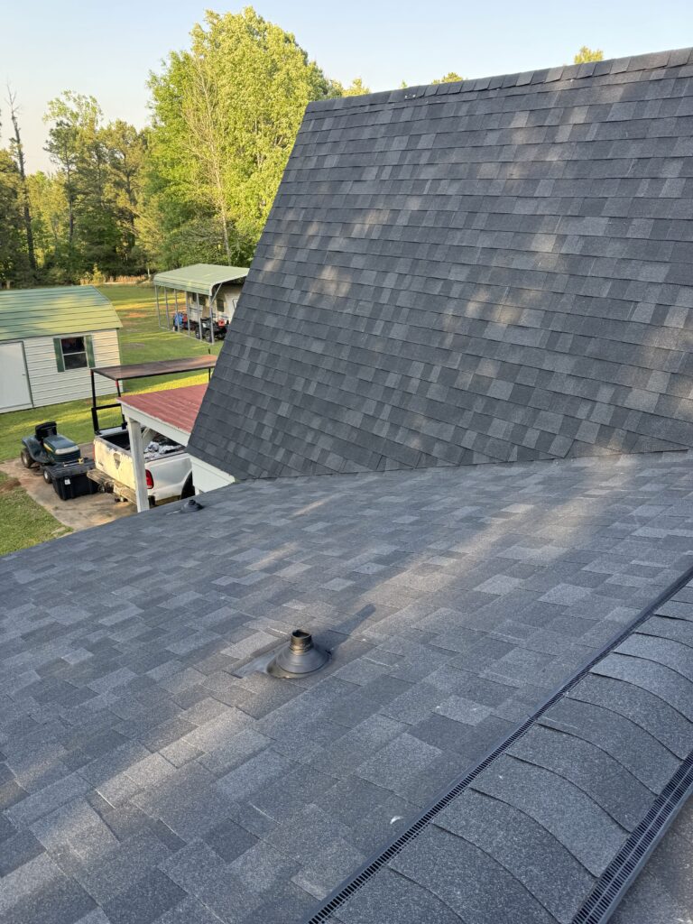 Gray shingled roofs with greenery background