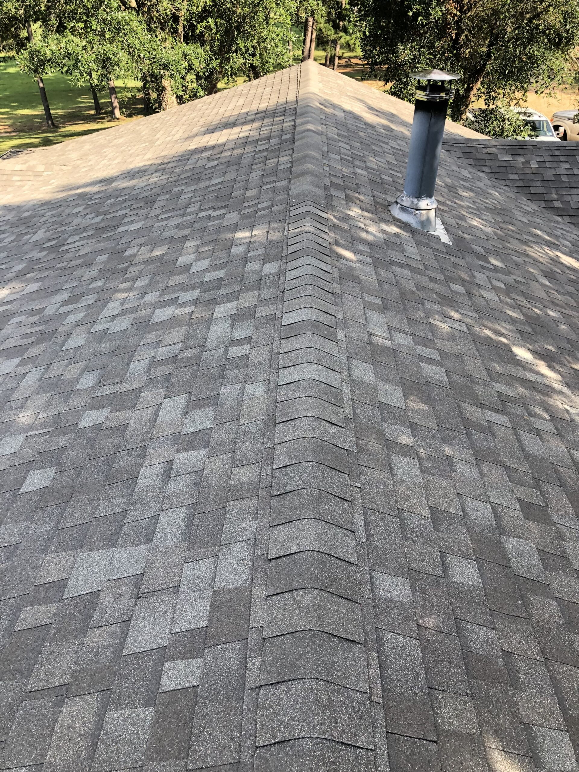 Gray shingle roof with chimney. Shingle roofing material project