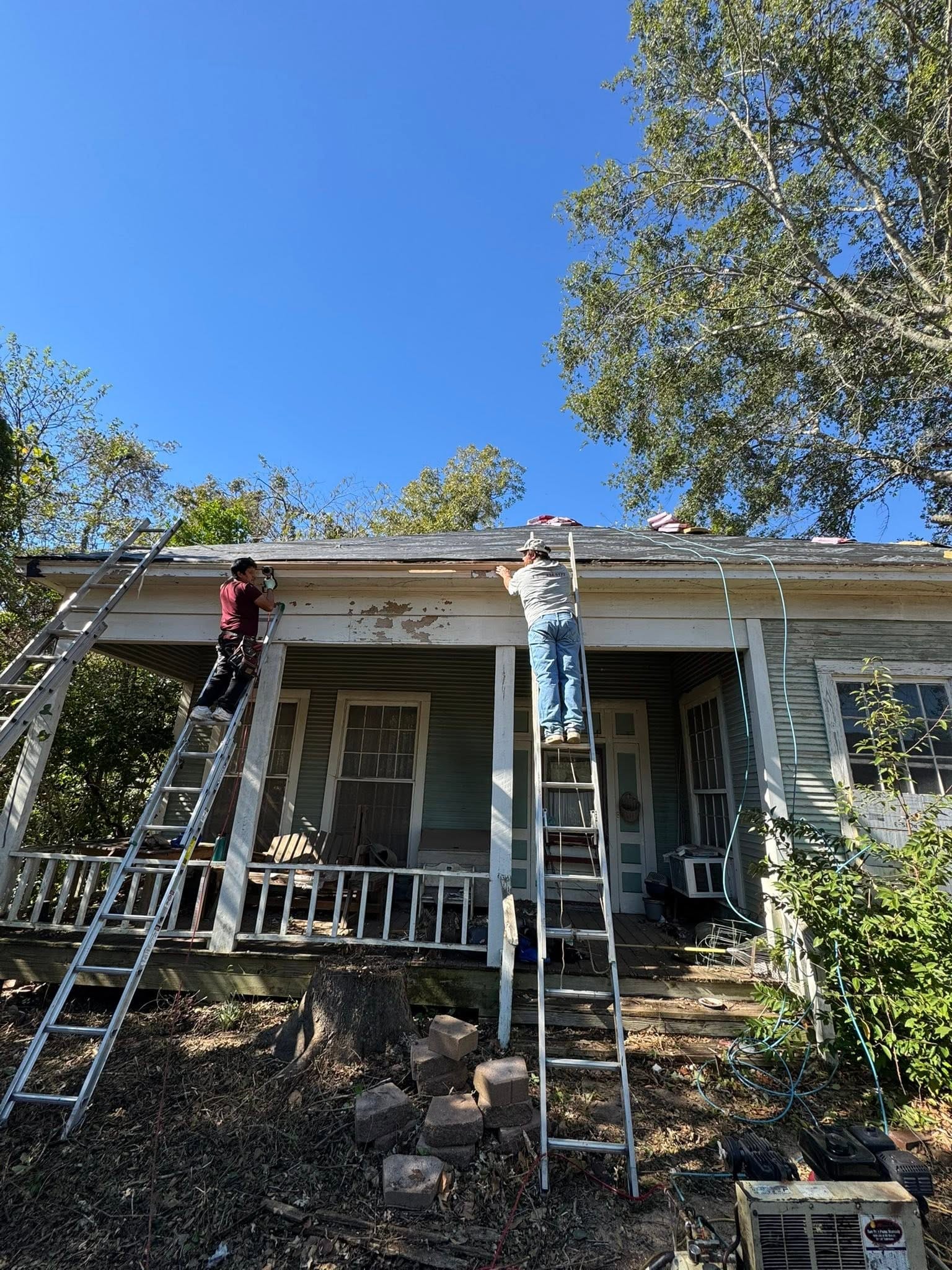 Workers repairing a house roof
