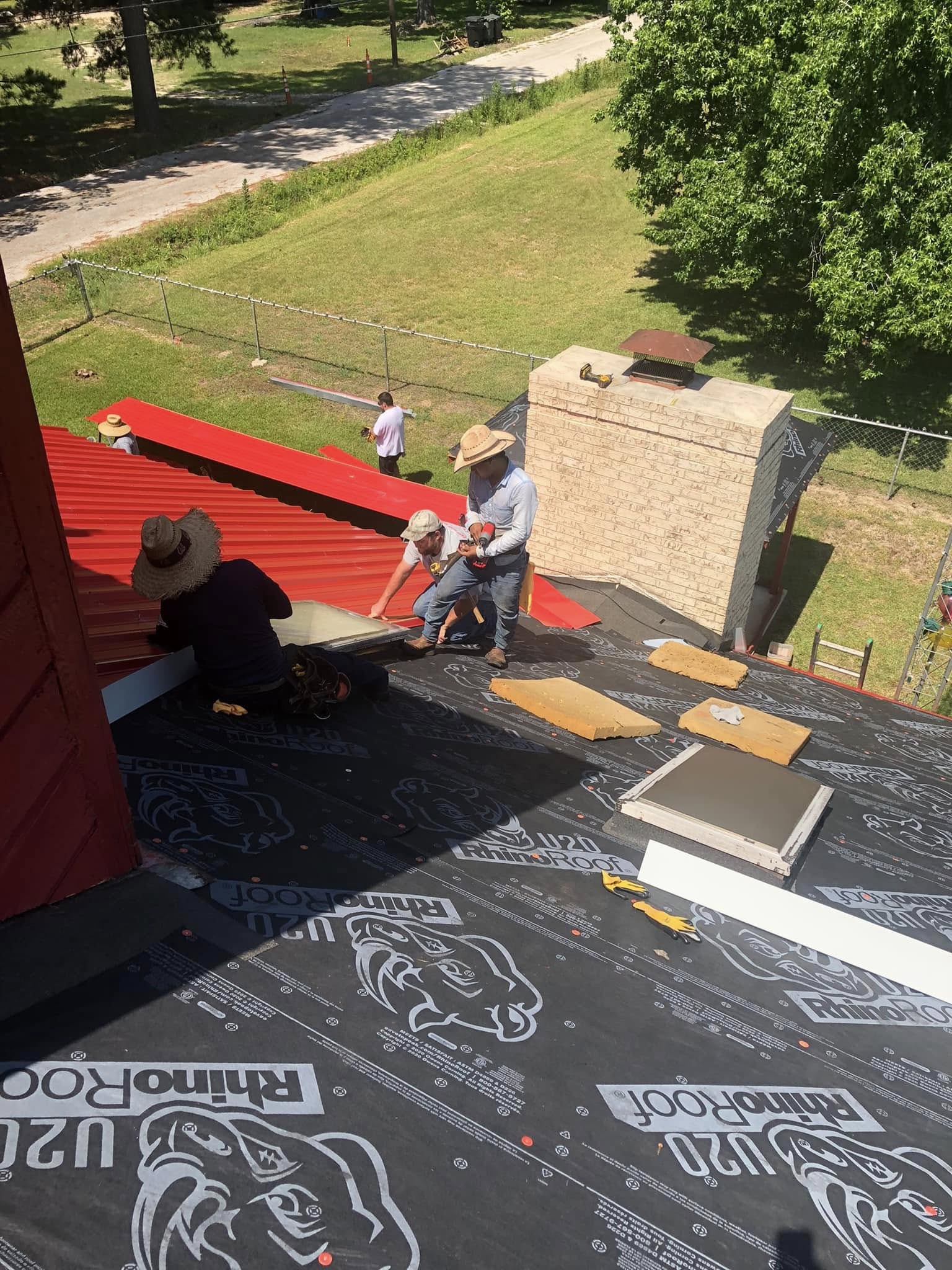 east texas roofing team working on roof